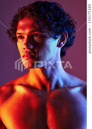 Light, shirtless or man in studio with art lighting and thinking with self care and neon. Focus, isolated and dark background of an attractive male model with artistic, creative and wellness fitness 134175389