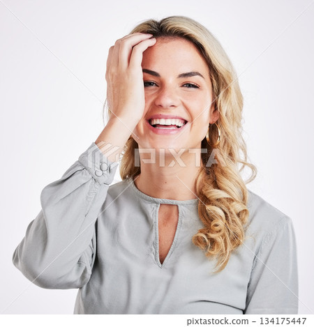 Portrait, happy and carefree with a woman on a gray background in studio feeling positive. Face, smile and kindness with an attractive young female gen z model looking cheerful against a color wall Portrait, happy and carefree with a woman on a gray background in studio feeling positive. Face, smile and kindness with an attractive young female gen z model looking cheerful against a color wall 134175447