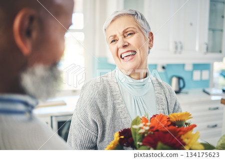 Love, gift and senior couple with flowers, smile and loving at home, bonding and romance. Romantic, man and woman with floral present, celebrate anniversary and relationship with joy and quality time 134175623