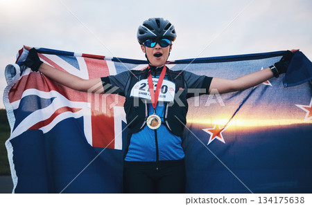 Winner sports, happy woman and flag with gold medal for winning outdoor cycling race or New Zealand triathlon. Happiness, win and success cyclist in wow, fitness and world record with national pride. Winner sports, happy woman and flag with gold medal for winning outdoor cycling race or New Zealand triathlon. Happiness, win and success cyclist in wow, fitness and world record with national pride. 134175638