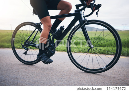 Closeup, legs and athlete on bicycle outdoor for exercise, training and triathlon sports. Person, bike and cycling on road for freedom, cardio fitness and performance with speed, power and transport 134175672