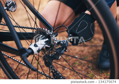 Cycling, repair and tire with hands of person in nature for fixing, adventure and safety. Fixing, ready and check with cyclist and wheel of bike on trail for gears, maintenance and inspection Cycling, repair and tire with hands of person in nature for fixing, adventure and safety. Fixing, ready and check with cyclist and wheel of bike on trail for gears, maintenance and inspection 134175674