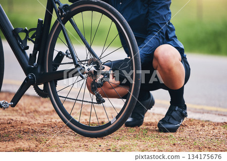 Person, bike and wheel repair outdoor for training, triathlon sports and transportation problem. Closeup of athlete, bicycle and check tire chain for travel safety, cycling maintenance and fixing hub 134175676