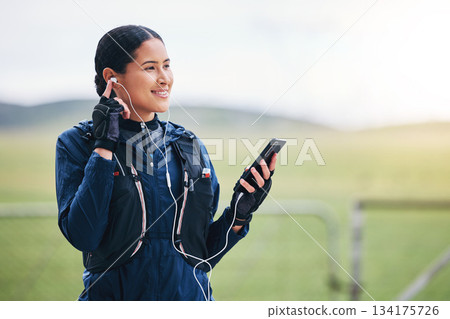 Music, phone and woman smile in the countryside ready for fitness and exercise with mockup. Sports, training and mobile headphones of a female athlete with internet audio and web radio for workout Music, phone and woman smile in the countryside ready for fitness and exercise with mockup. Sports, training and mobile headphones of a female athlete with internet audio and web radio for workout 134175726