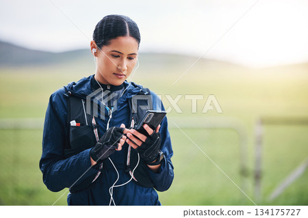 Music, phone and woman in the countryside ready for fitness and exercise with mockup. Sports, training and mobile headphones of a female athlete looking at gps with audio and web radio for workout Music, phone and woman in the countryside ready for fitness and exercise with mockup. Sports, training and mobile headphones of a female athlete looking at gps with audio and web radio for workout 134175727