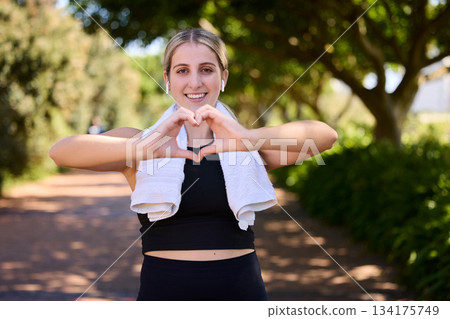 Fitness, heart hands or portrait of happy woman in park for running exercise or workout for body health. Heart sign, self love or active girl athlete runner in sports training for wellness in nature Fitness, heart hands or portrait of happy woman in park for running exercise or workout for body health. Heart sign, self love or active girl athlete runner in sports training for wellness in nature 134175749
