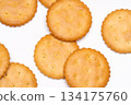 A simple composition of round biscuits arranged on a white background 134175760