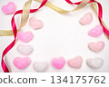 Decorative composition on a white background with heart ornaments and ribbon borders 134175762