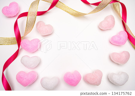 Decorative composition on a white background with heart ornaments and ribbon borders Decorative composition on a white background with heart ornaments and ribbon borders 134175762