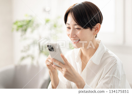 Woman holding a smartphone Woman holding a smartphone 134175851