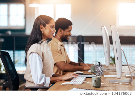 Happy, coworking office and employees with a computer, working together and online communication. Smile, our vision and diversity with workers sitting at a desk typing on a pc for a corporate job 134176062