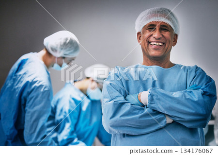 Theatre, portrait and man doctor with arms crossed for hospital teamwork, leadership and medical surgery. Happy surgeon or healthcare person in operating room or theater for emergency and solution 134176067