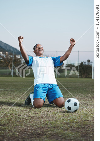 Soccer ball, sports and man celebrate goal on field for competition, fitness or training outdoor. Black male athlete football player, pitch and game celebration for sport achievement, success or win 134176091