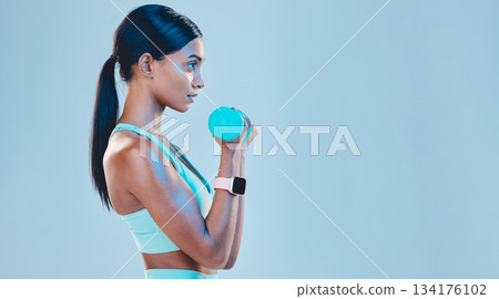 Sports, workout and female with weights in studio for arm or strength training with motivation. Fitness, exercise and Indian woman athlete with dumbells isolated by blue background with mockup space. 134176102