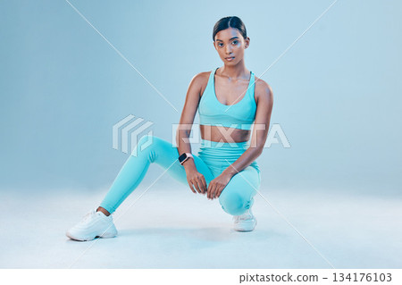 Fitness, portrait and focus with a sports woman in studio on a blue background for health or wellness. Exercise, mindset and serious with a female athlete training for a healthy body or lifestyle Fitness, portrait and focus with a sports woman in studio on a blue background for health or wellness. Exercise, mindset and serious with a female athlete training for a healthy body or lifestyle 134176103
