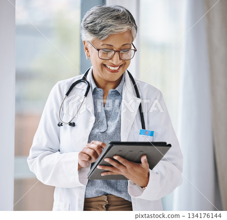 Senior doctor, woman with tablet and digital medical results with hospital schedule and healthcare information online. Happy female physician, health insurance and professional in medicine with tech Senior doctor, woman with tablet and digital medical results with hospital schedule and healthcare information online. Happy female physician, health insurance and professional in medicine with tech 134176144