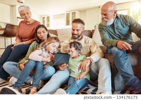 Love, home and family on a couch, tablet and streaming movies on break, weekend and relax together. Grandparents, mother or father with children, siblings or kids in lounge, social media and chilling 134176175