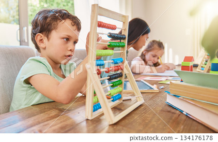 Education, maths and a boy counting on an abacus while learning in the living room of his home. Children, homework and study with a male school kid in his house for growth or child development Education, maths and a boy counting on an abacus while learning in the living room of his home. Children, homework and study with a male school kid in his house for growth or child development 134176178