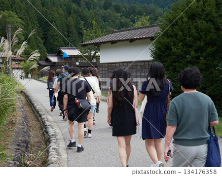Foreign tourists strolling through Shirakawa Village, a World Heritage Site in Shirakawa-go, and the Gassho-style houses Foreign tourists strolling through Shirakawa Village, a World Heritage Site in Shirakawa-go, and the Gassho-style houses 134176358