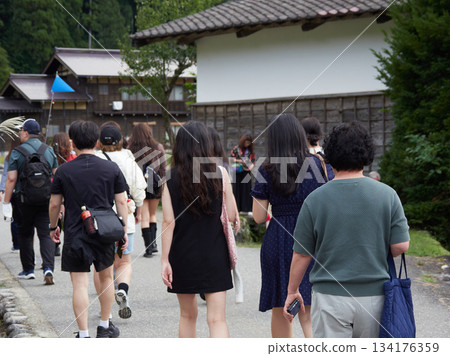 Foreign tourists strolling through Shirakawa Village, a World Heritage Site in Shirakawa-go, and the Gassho-style houses Foreign tourists strolling through Shirakawa Village, a World Heritage Site in Shirakawa-go, and the Gassho-style houses 134176359