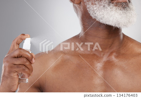 Senior man with spray bottle, cologne and grooming with beauty and cosmetic fragrance isolated on studio background. Skin, cosmetics product and perfume deodorant with clean male person and hygiene 134176403