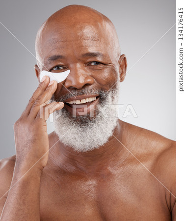 Skincare, eye pad or portrait of man with smile, happiness and anti ageing face treatment. Dermatology, cosmetic grooming or happy, mature and African model or collagen eyes mask on white background 134176415