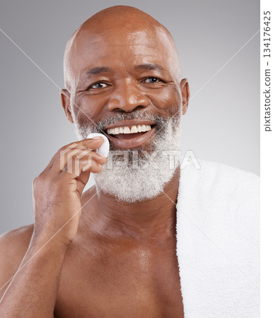 Skincare, cotton pad and portrait of man with happiness, cleaning or luxury bathroom routine. Dermatology, cosmetic process and happy, mature African model and anti ageing morning cleansing treatment Skincare, cotton pad and portrait of man with happiness, cleaning or luxury bathroom routine. Dermatology, cosmetic process and happy, mature African model and anti ageing morning cleansing treatment 134176425