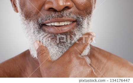 Beauty, hand and beard with a senior man in studio on a gray background for skincare or grooming. Mouth, smile and facial hair with a happy mature male closeup for a luxury cosmetic facial product Beauty, hand and beard with a senior man in studio on a gray background for skincare or grooming. Mouth, smile and facial hair with a happy mature male closeup for a luxury cosmetic facial product 134176447