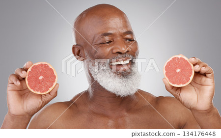 Senior black man, grapefruit and smile for skincare, natural nutrition or vitamin c against a gray studio background. Happy African American male holding fruit for healthy skin, diet or wellness Senior black man, grapefruit and smile for skincare, natural nutrition or vitamin c against a gray studio background. Happy African American male holding fruit for healthy skin, diet or wellness 134176448