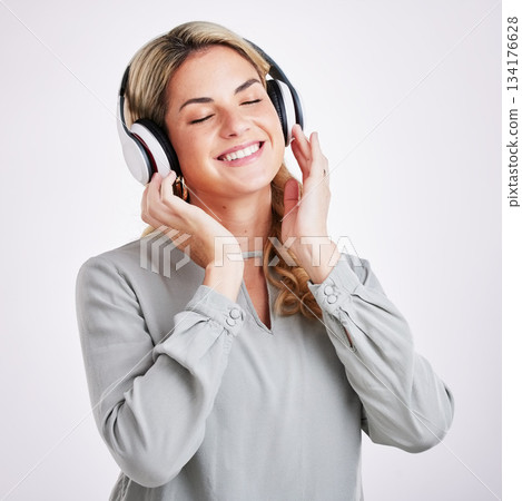 Music, smile and happy woman in studio with headphones for audio track on grey background. Radio, relax and excited female with earphones for podcast, playlist and online, streaming and subscription Music, smile and happy woman in studio with headphones for audio track on grey background. Radio, relax and excited female with earphones for podcast, playlist and online, streaming and subscription 134176628