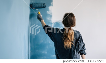 Woman in yellow sweater checks grocery shopping list while pushing cart filled with fresh vegetables and fruits in a supermarket aisle, showcasing organized shopping experience 134177229
