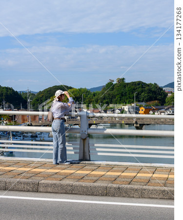 Woman looking at the harbor view Woman looking at the harbor view 134177268