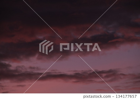 Dark ominous clouds filling dramatic purple twilight sky. Dark ominous clouds filling dramatic purple twilight sky. 134177657