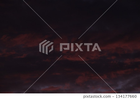 Dark red dramatic clouds background texture during deep twilight. Dark red dramatic clouds background texture during deep twilight. 134177660