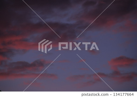Dark sunset clouds coloring purple twilight sky drama. 134177664