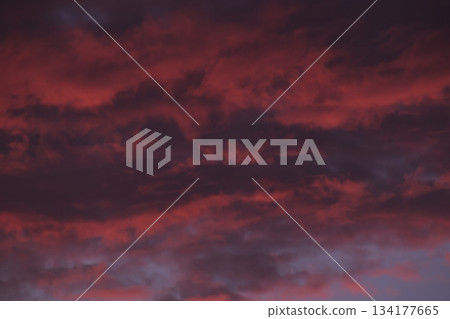 Fiery red storm clouds moving across dark sky background 134177665