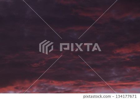 Dramatic sunset sky with dark purple red storm clouds background. Dramatic sunset sky with dark purple red storm clouds background. 134177671