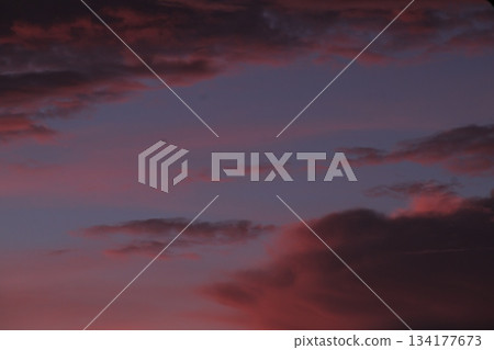 Dramatic sunset clouds coloring purple and red sky background. Dramatic sunset clouds coloring purple and red sky background. 134177673