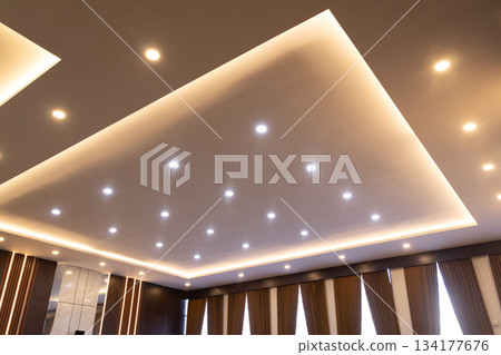 Modern ceiling design features recessed spot lights and warm LED cove lighting. Modern ceiling design features recessed spot lights and warm LED cove lighting. 134177676