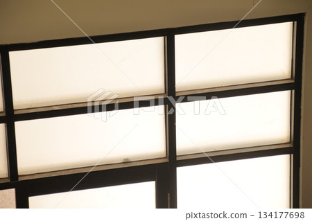 Frosted window panes bright light geometric pattern detail. Frosted window panes bright light geometric pattern detail. 134177698