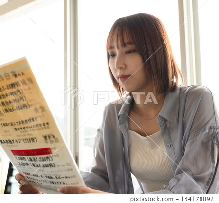 Women browsing the menu Women browsing the menu 134178092