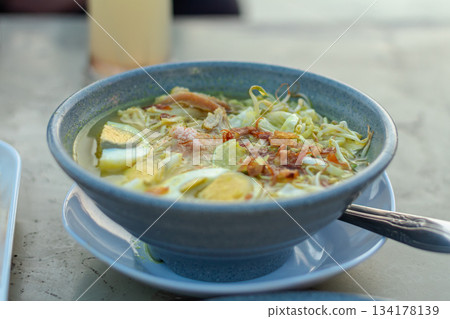 Traditional Indonesian Soto Ayam Chicken Soup with Turmeric Broth and Hard Boiled Eggs 134178139