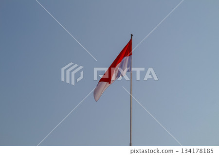 Indonesian National Flag Sang Saka Merah Putih waving proudly against clear blue sky Indonesian National Flag Sang Saka Merah Putih waving proudly against clear blue sky 134178185