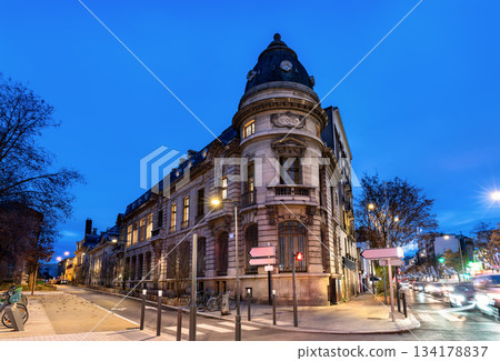 Historic administrative building stands on a street corner in Saint-Ouen-sur-Seine near Paris, France. Eclectic architecture features a stone facade and slate dome with "St Ouen" inscription Historic administrative building stands on a street corner in Saint-Ouen-sur-Seine near Paris, France. Eclectic architecture features a stone facade and slate dome with "St Ouen" inscription 134178837