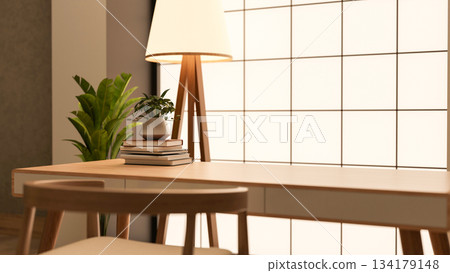 Potted plant over books on wooden table with chair aside high floor lamp in a glass tiles wall room. Potted plant over books on wooden table with chair aside high floor lamp in a glass tiles wall room. 134179148