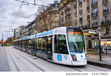 Paris, France - December 3, 2025: Alstom Citadis tram arrives at Porte de Saint-Ouen station. Modern T3b line vehicle connects the 17th and 18th arrondissements of Paris in Ile-de-France region 134179683