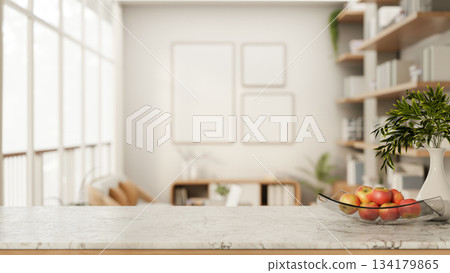 Apples on glass plate aside ceramic vase on marble counter table in white living room or modern cafe Apples on glass plate aside ceramic vase on marble counter table in white living room or modern cafe 134179865