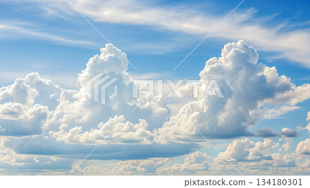 White fluffy cumulus clouds in bright blue sky background illustrating summer weather and heaven atmosphere concept with copy space area 134180301