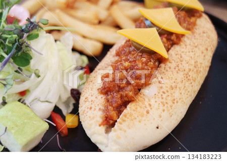 Chili hot dogs with fries and salad Chili hot dogs with fries and salad 134183223