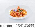 Tomato sauce pasta topped with edible flowers 134183655